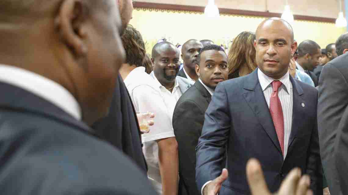 Haitian Prime Minister, Laurent Lamothe, greets a throng of guests and well-wishers as he enters the center.